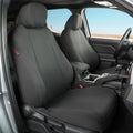 Canvas Black car seat covers installed on the front seats of a vehicle interior, shown with the door open and dashboard visible.