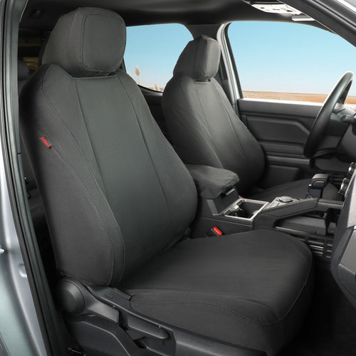 Canvas Black car seat covers installed on the front seats of a vehicle interior, shown with the door open and dashboard visible.