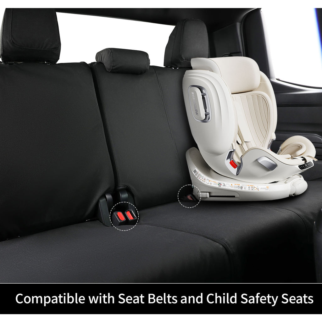 A black car seat cover installed on a three-seat vehicle rear bench, shown alongside a cream child safety seat. The image includes a text overlay at the bottom reading 'Compatible with Seat Belts and Child Safety Seats'.