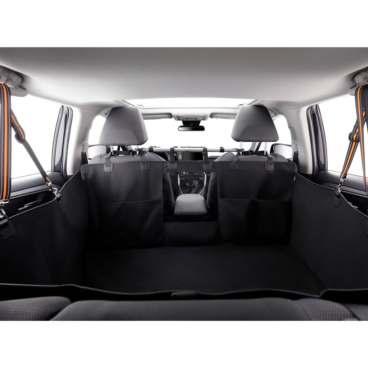 Black cargo liner and seat covers installed in the trunk of a vehicle, with the rear seats folded down to show the installed fit.