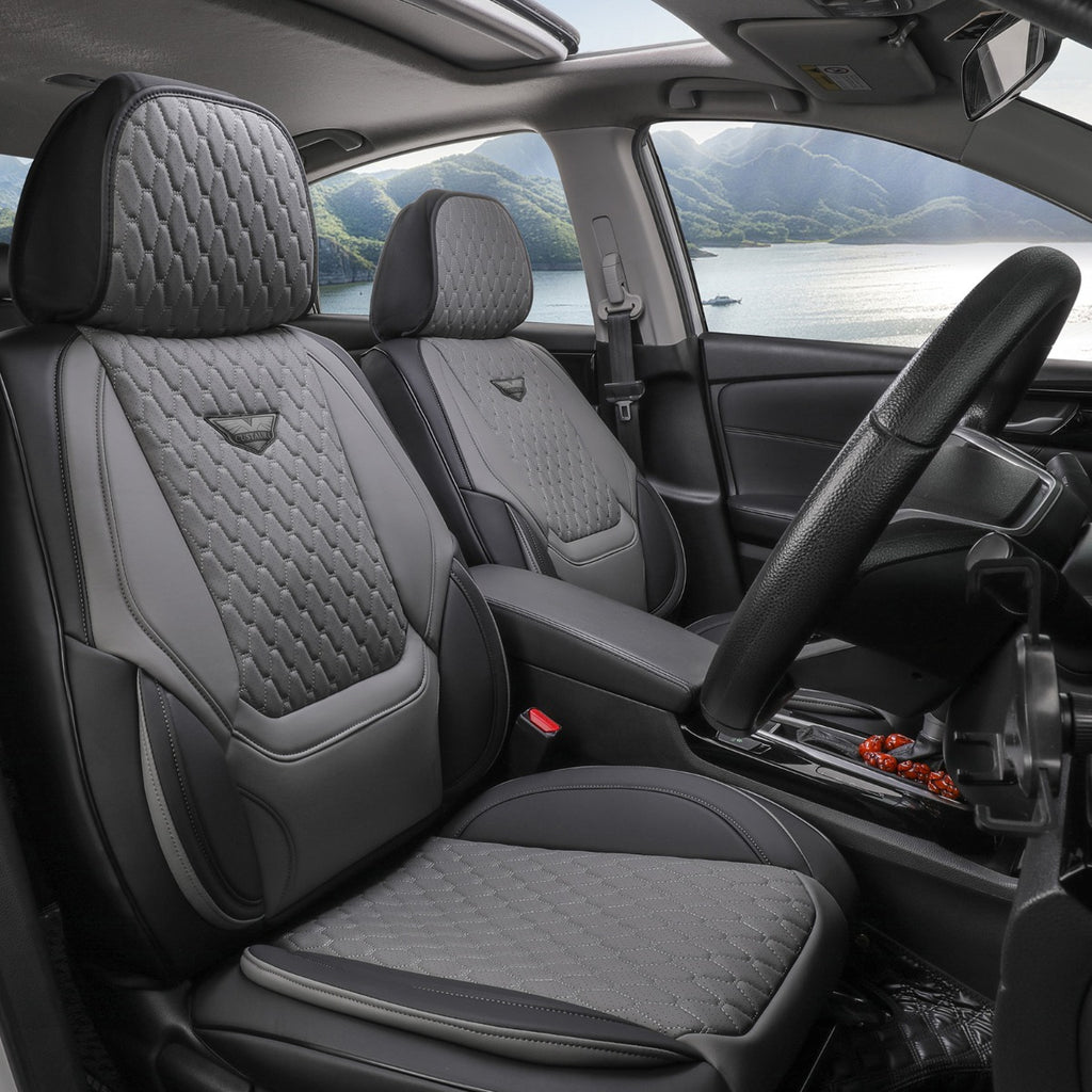 Car interior with gray quilted seat covers and a scenic view outside the window.