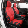 Red and black car seat covers installed on the front seats of a vehicle, shown from the open driver-side door. The covers have a quilted diamond pattern and are fitted over the seats inside a black car interior.