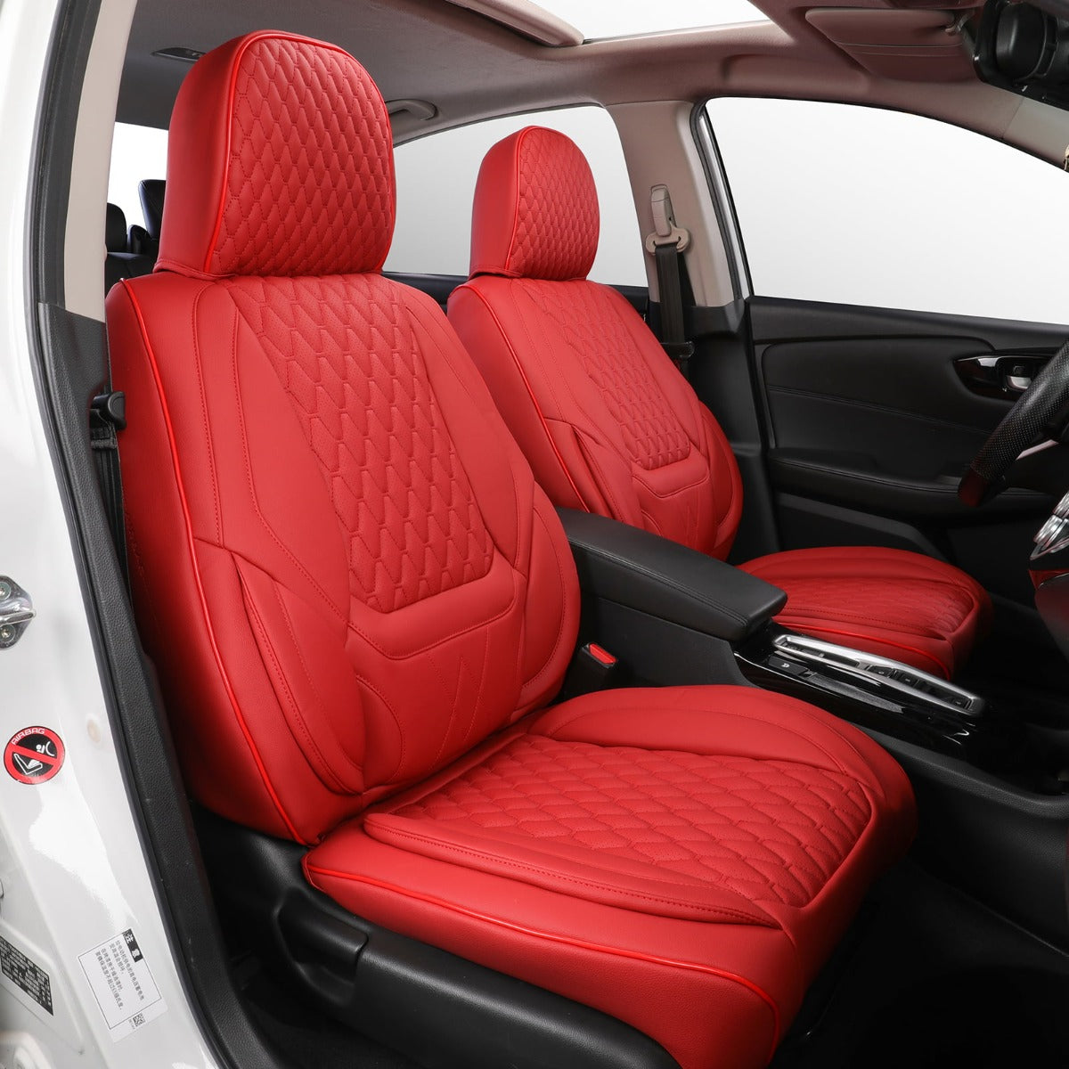 Red car seat covers with quilted pattern in a vehicle interior.
