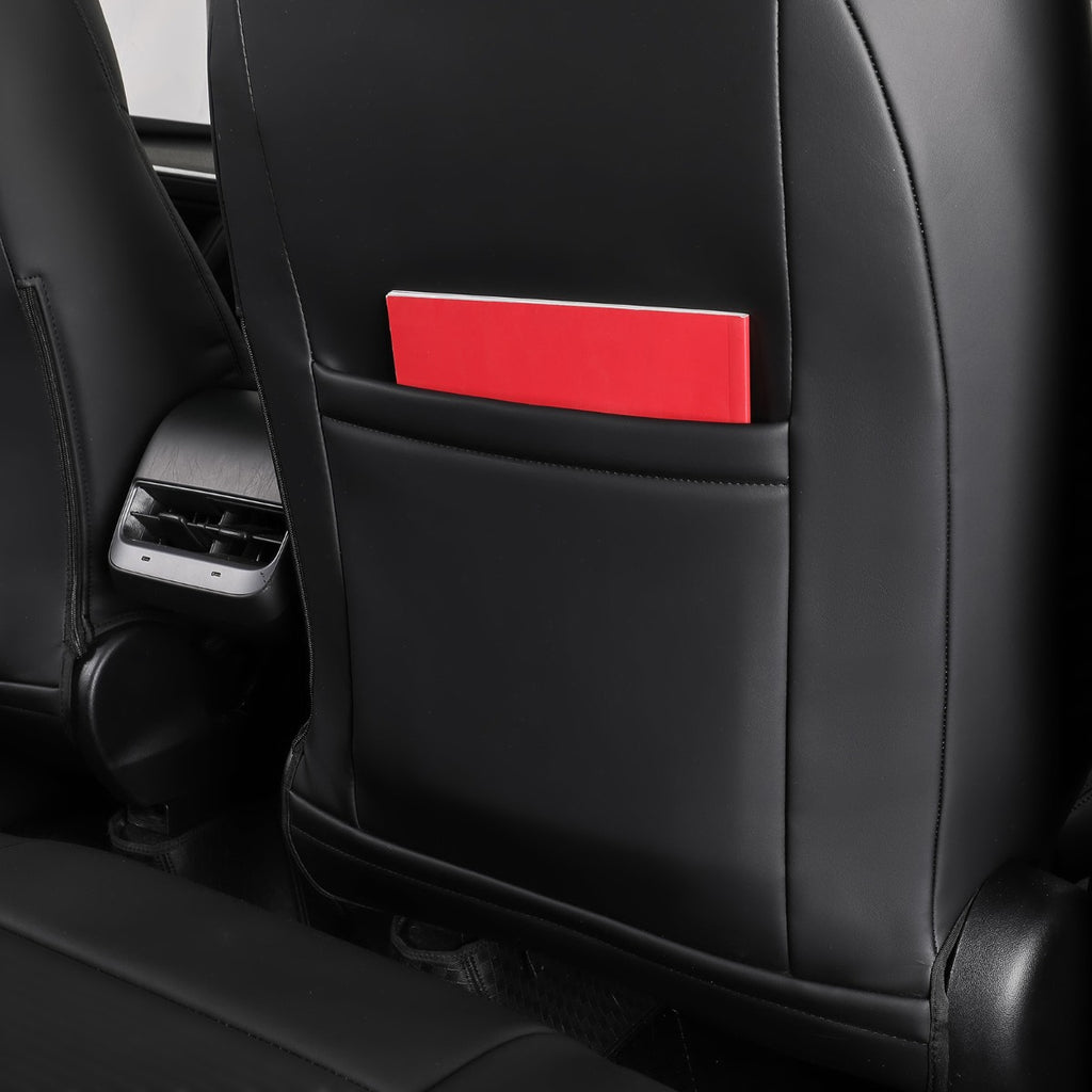 A close-up of a black leather car seat back with a red rectangular insert or pocket shown in the seat back pocket.