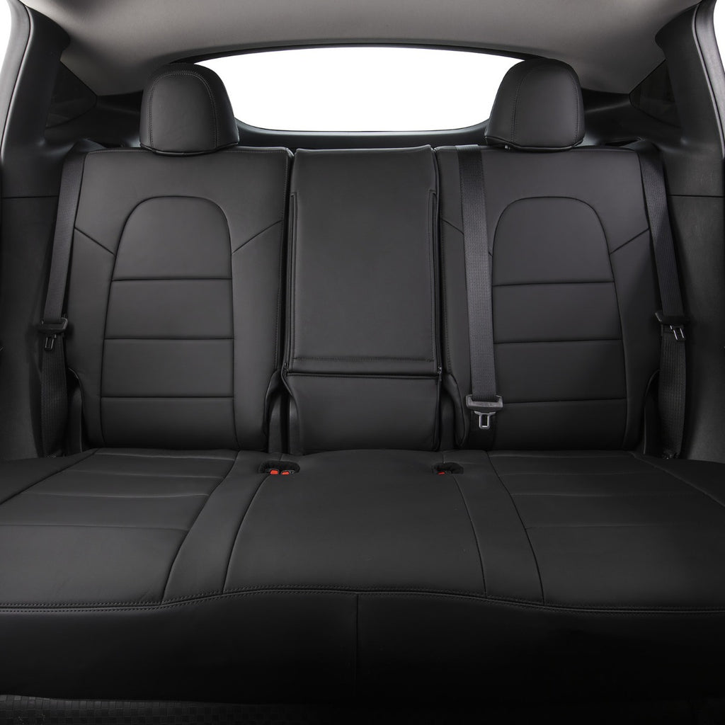 Black leather car rear seat bench with integrated headrests and seatbelts, shown from the front-facing rear cargo area.