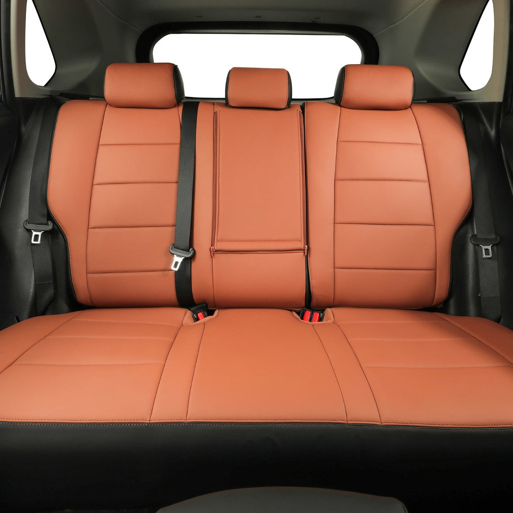 A set of custom car seat covers installed on the rear bench of a vehicle, featuring a warm Brown -brown leather-like finish with black side bolsters and seatbelts.