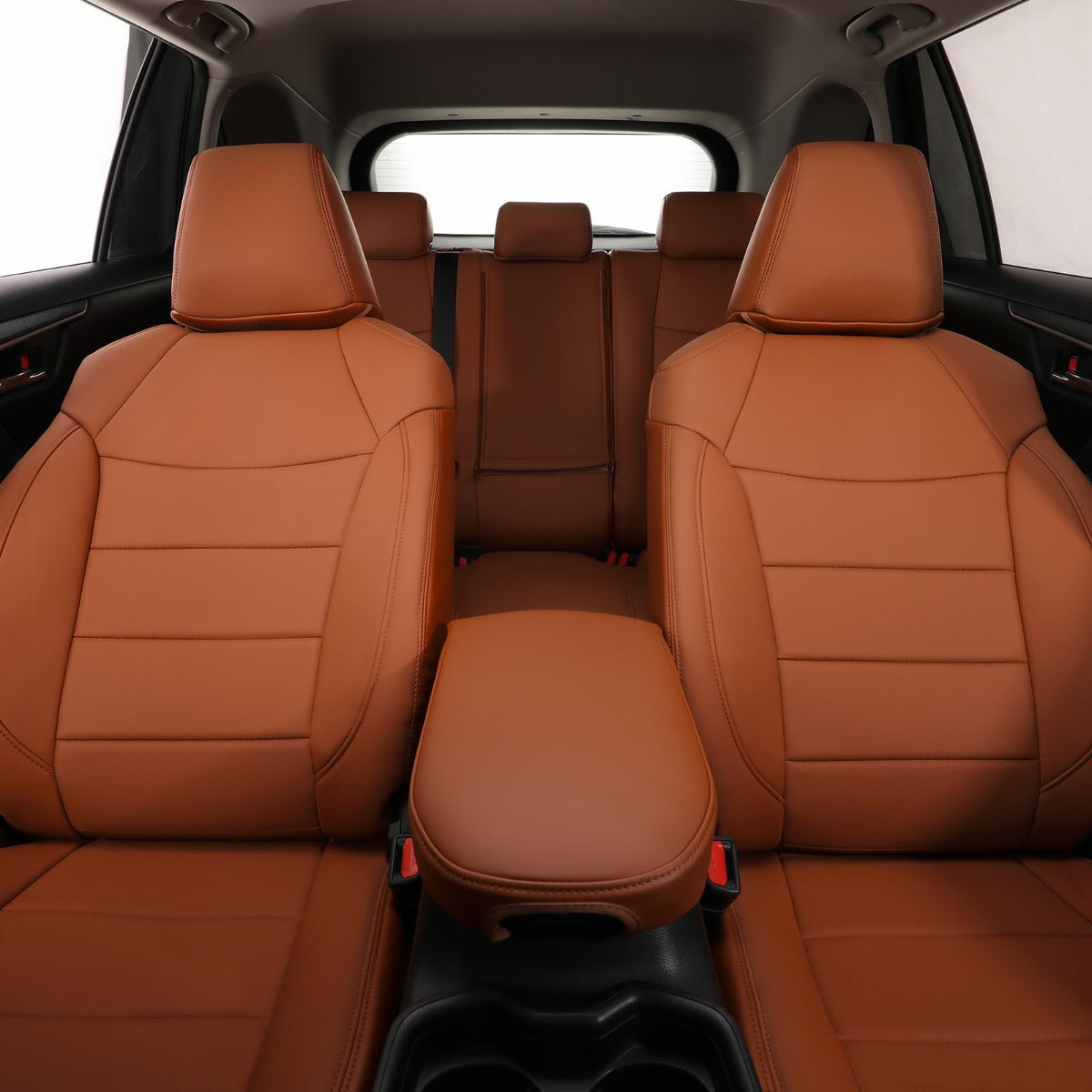 Brown leather car seat covers installed on the front seats of a vehicle, with a matching center console armrest and black cup holders visible in the center.