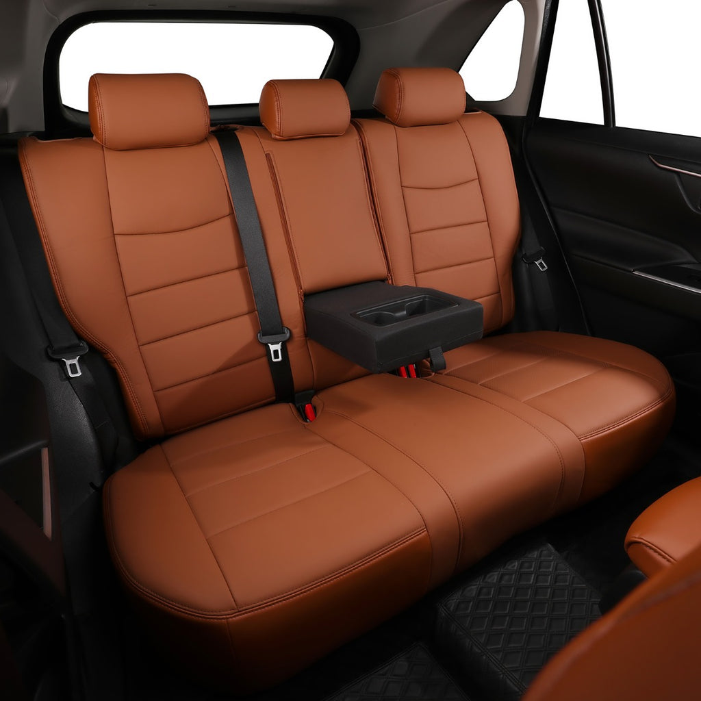 Brown leather car rear seat covers installed on a three-seat vehicle back, with a black center armrest and seatbelts visible inside the car cabin.
