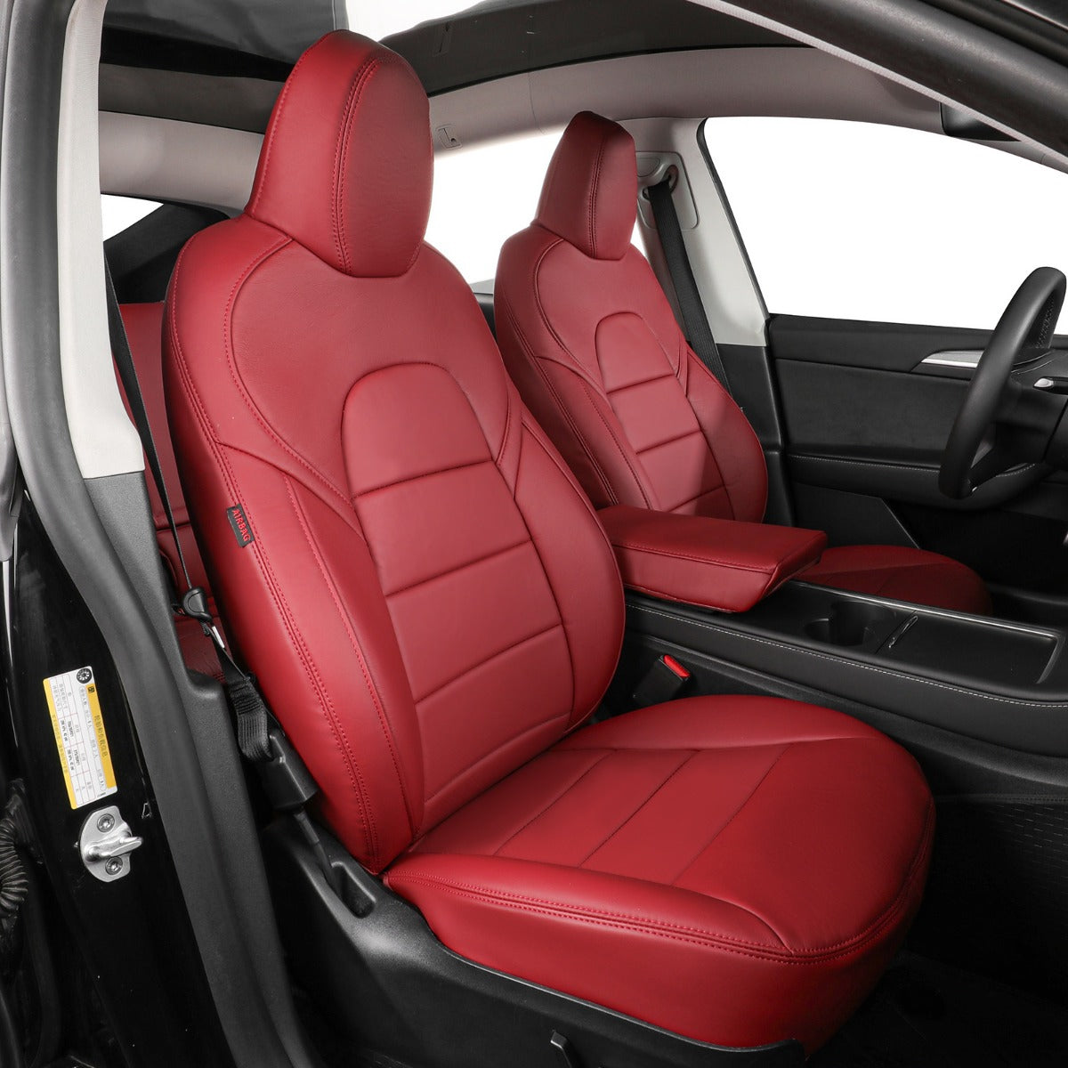 Burgundy leather car seat covers installed on the front seats of a vehicle, shown from the open driver's side door with the black interior visible.