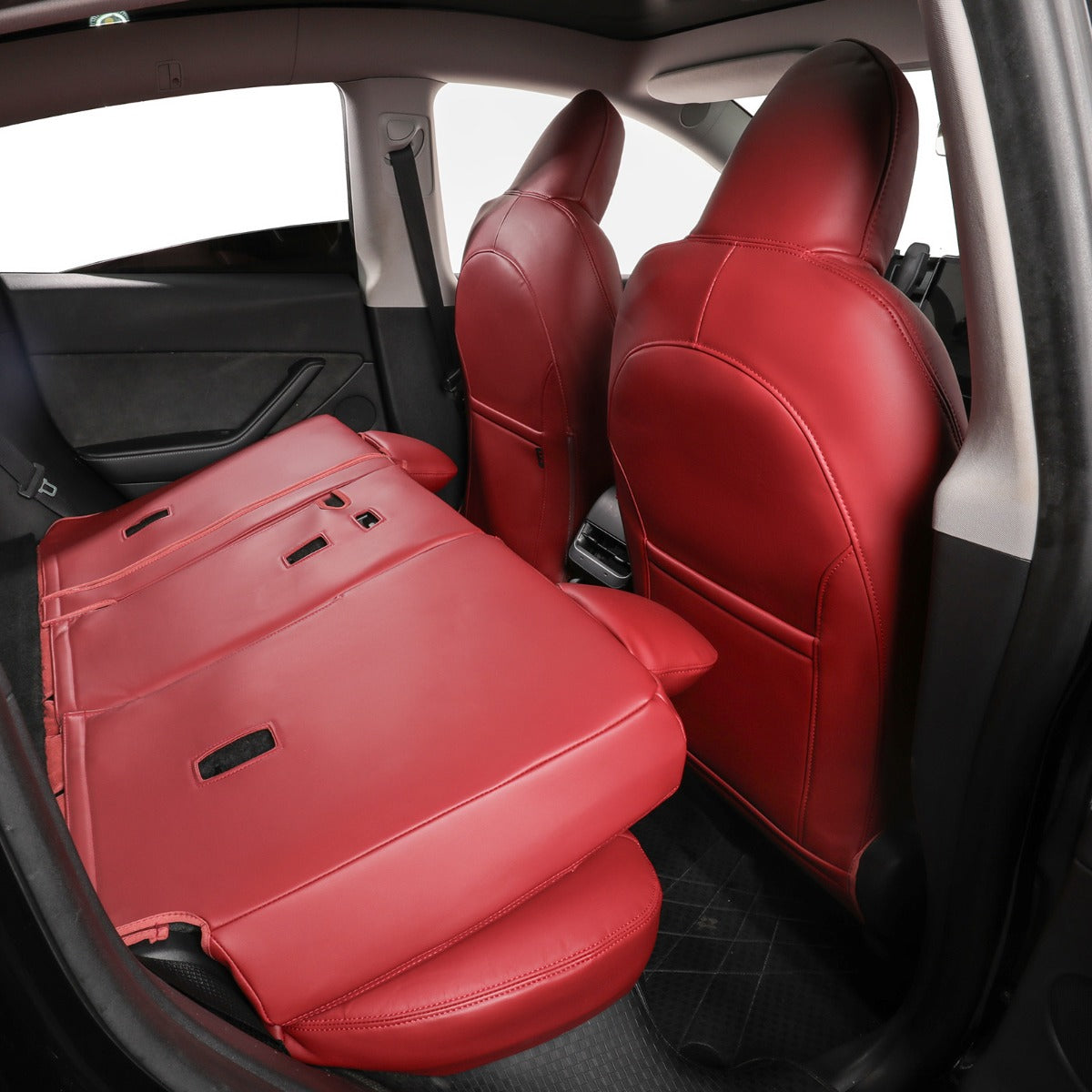 Burgundy leather car seat covers installed on the front and rear seats of a vehicle interior.