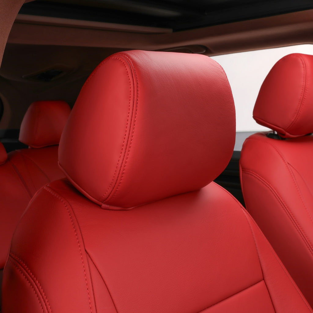 Close-up of bright red car seat headrests and part of the seat bolsters inside a vehicle cabin.