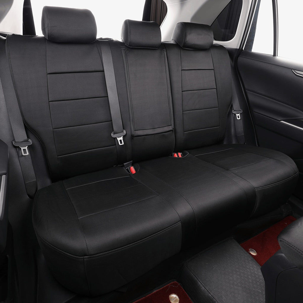 Black car rear seat covers fitted over a three-seat bench, shown inside a vehicle cabin with seatbelts visible.