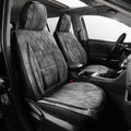 A pair of gray and black plaid car seat covers installed on the front seats of a vehicle interior.