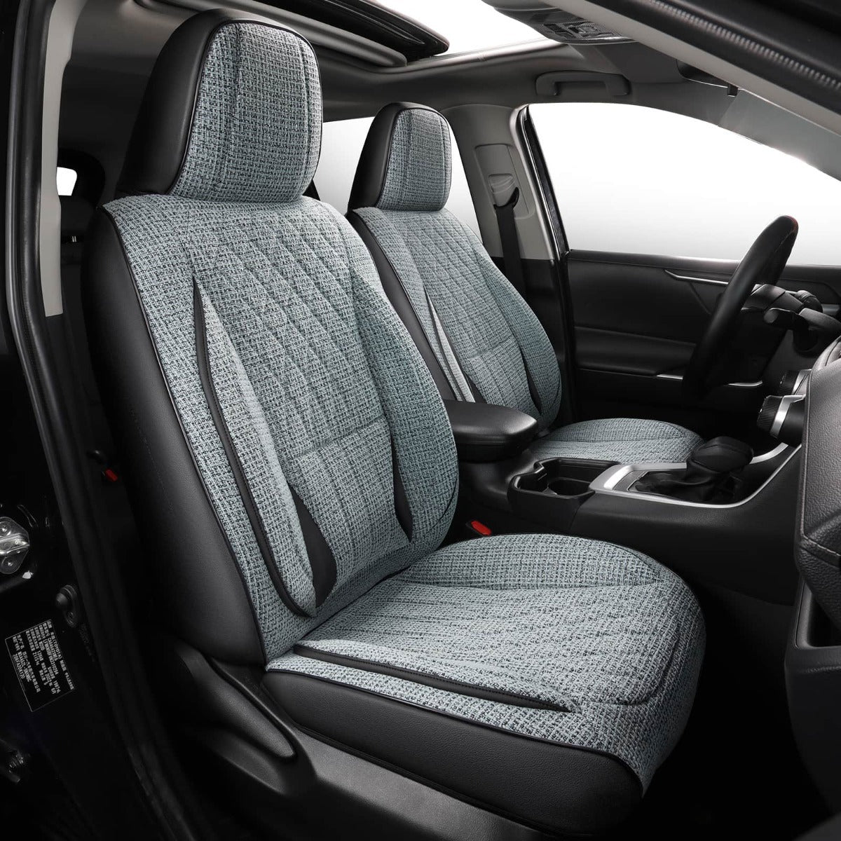 Car interior with gray and blue  quilted seat covers on black seats
