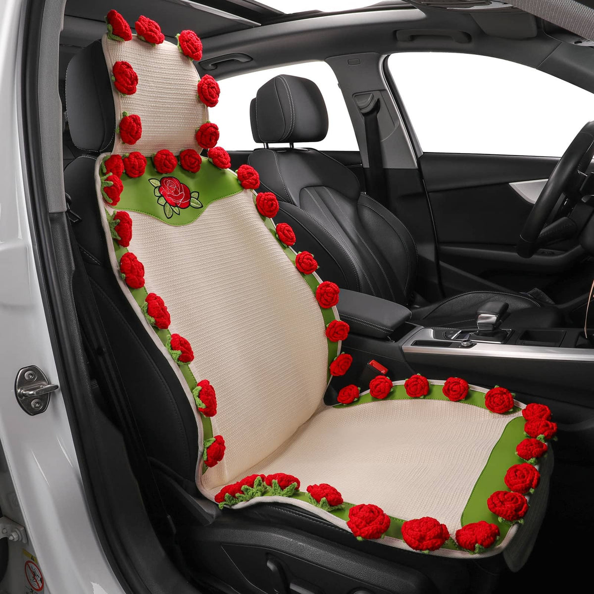 Car seat cover with red floral design inside a vehicle