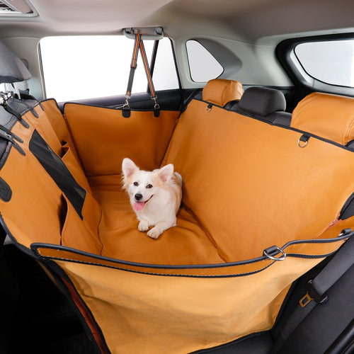 Dog sitting on an brown car seat cover in a vehicle