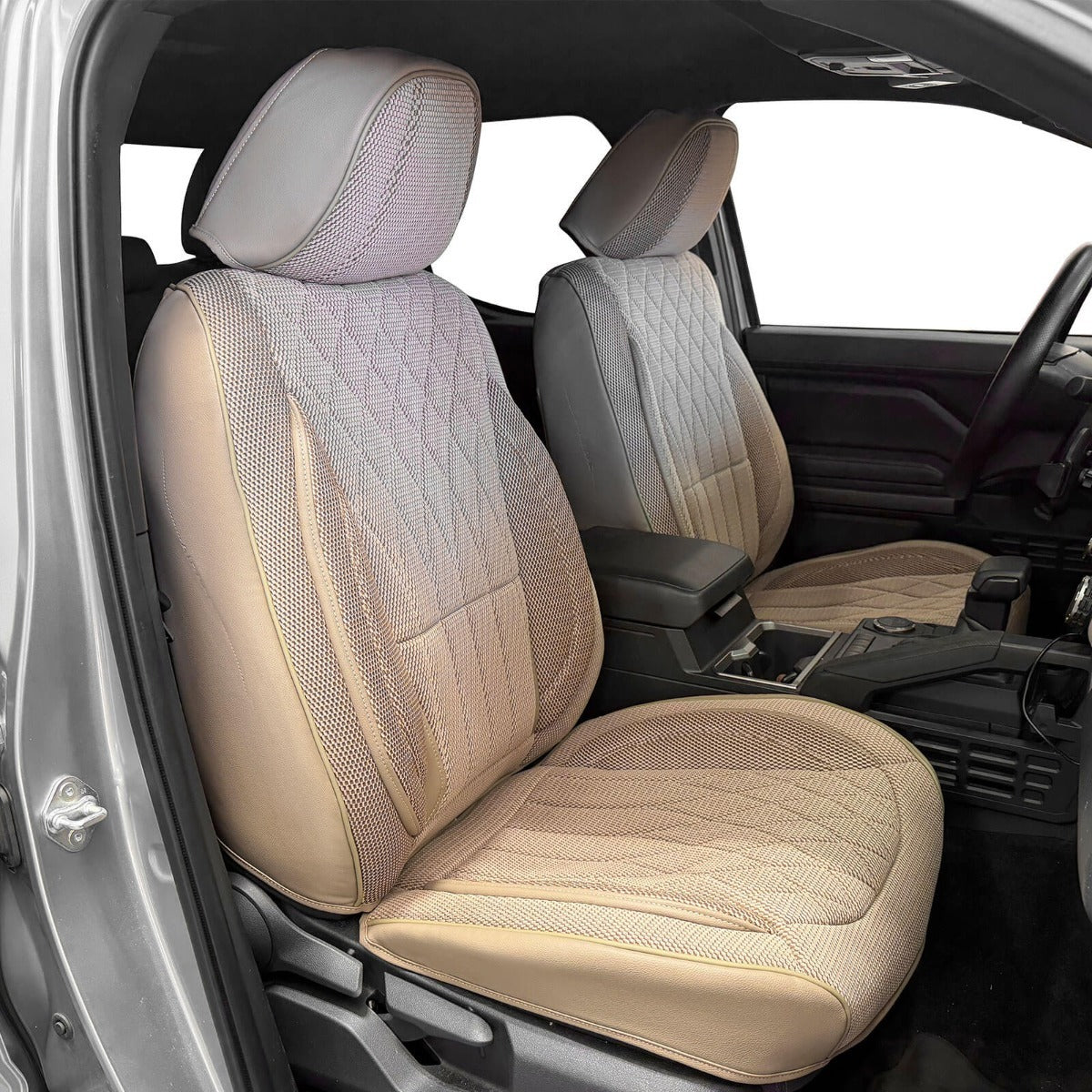 Khaki mesh car seat covers installed on the front seats of a vehicle, shown from the open driver's side door.